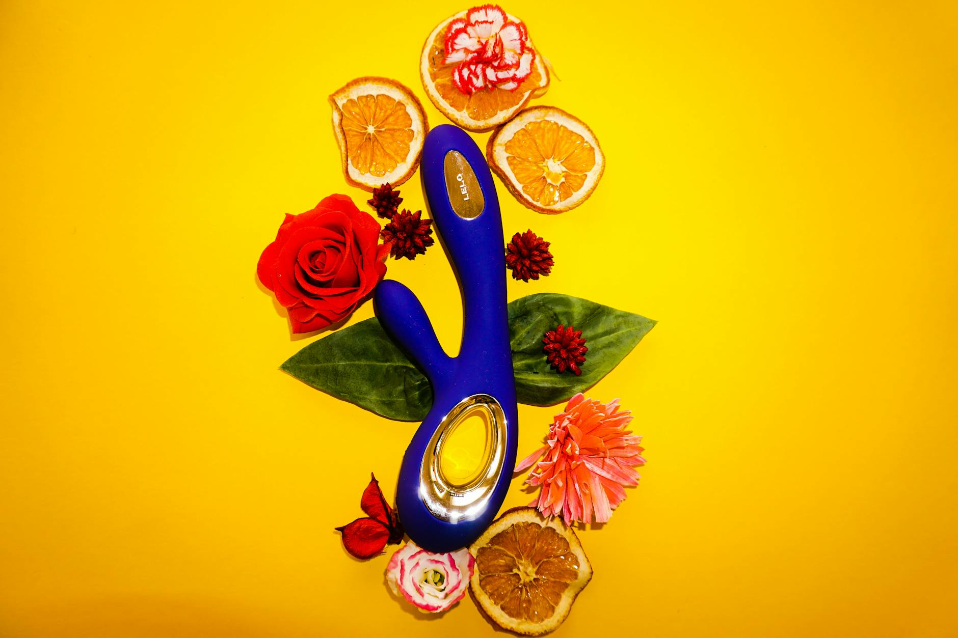 Two hands holding a basket of colorful vibrators and flowers together